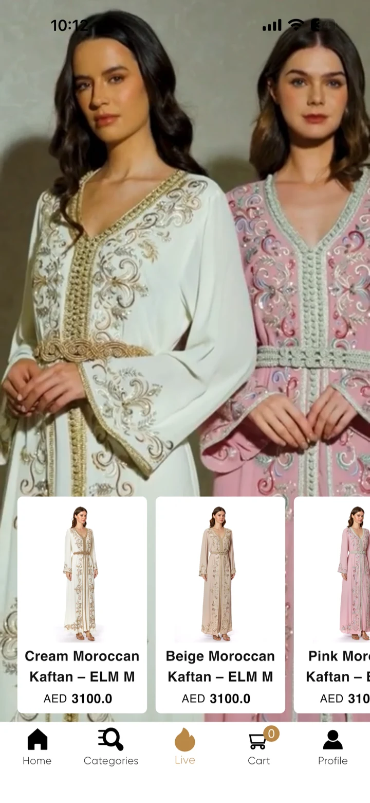 Eleganza La Mode app Live tab: full-screen video of two models in kaftans with buyable product cards along the bottom